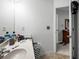 Bathroom with a single sink vanity with adjacent access to a bedroom at 320 Little Creek Rd, Lawrenceville, GA 30045