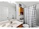 Functional bathroom featuring a single vanity with storage and a shower/tub combination with a curtain at 320 Little Creek Rd, Lawrenceville, GA 30045