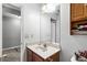 Bright bathroom featuring a white vanity, a large mirror, and wooden storage, offering a functional design at 320 Little Creek Rd, Lawrenceville, GA 30045