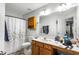 Standard bathroom with a single sink vanity, shower with curtain, and overhead lighting at 320 Little Creek Rd, Lawrenceville, GA 30045