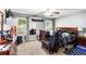 Bedroom featuring ceiling fan, several windows, carpet, a bed, and wooden furniture at 320 Little Creek Rd, Lawrenceville, GA 30045