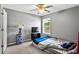 Bedroom featuring ceiling fan, a street view window, carpet, and practical setup at 320 Little Creek Rd, Lawrenceville, GA 30045