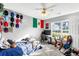 Well-lit bedroom featuring ceiling fan, a bright window, carpet, and comfortable bed with a desk and chair at 320 Little Creek Rd, Lawrenceville, GA 30045