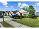 Well-maintained home featuring a lush lawn, manicured bushes, and a black truck parked on the driveway at 320 Little Creek Rd, Lawrenceville, GA 30045
