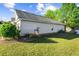 Home exterior with siding, lush lawn and mature landscaping at 320 Little Creek Rd, Lawrenceville, GA 30045
