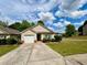 Charming home with manicured lawn, driveway, and a one-car garage under a blue sky at 320 Little Creek Rd, Lawrenceville, GA 30045