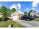 Home featuring a garage, a driveway, and well-kept lawn under a cloudy sky at 320 Little Creek Rd, Lawrenceville, GA 30045