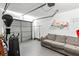 Organized garage space with a sofa, punching bag, and wall-mounted shelving and work out equipment at 320 Little Creek Rd, Lawrenceville, GA 30045