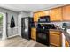 Well-lit kitchen with wood cabinets, modern appliances, and a window to the yard at 320 Little Creek Rd, Lawrenceville, GA 30045