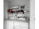 Functional laundry room with washer, dryer and wire shelving for storage at 320 Little Creek Rd, Lawrenceville, GA 30045