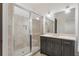Bathroom featuring glass enclosed shower, vanity with a sink, and modern lighting fixtures at 5920 Bond St # B206, Cumming, GA 30040