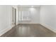 Bright bedroom features wood floors, plantation shutters, neutral paint, and ensuite bath at 5920 Bond St # B206, Cumming, GA 30040