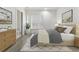 Cozy bedroom with a soft bed, neutral tones, and a window with natural light; bathroom in the background at 5920 Bond St # B206, Cumming, GA 30040