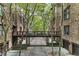Building exteriors are connected by walkways and surrounded by mature trees at 5920 Bond St # B206, Cumming, GA 30040