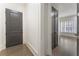Light and airy entryway with dark trim, wood floors, and access to the main living area of the home at 5920 Bond St # B206, Cumming, GA 30040