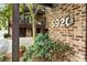 Exterior view featuring house number on brick wall with lush landscaping at 5920 Bond St # B206, Cumming, GA 30040