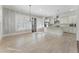 Open concept kitchen with white cabinets, stainless appliances, and a center island with granite countertops at 5920 Bond St # B206, Cumming, GA 30040