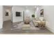 Comfortable living room with neutral decor, plush seating, a stylish rug, and hardwood floors at 5920 Bond St # B206, Cumming, GA 30040