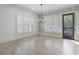 Bright living room featuring large windows with plantation shutters and light tile flooring at 5920 Bond St # B206, Cumming, GA 30040