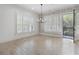 Bright living room boasts wood floors, plantation shutters, modern lighting, and access to the outdoor balcony at 5920 Bond St # B206, Cumming, GA 30040
