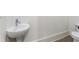 Cozy powder room featuring a pedestal sink and toilet at 5920 Bond St # B206, Cumming, GA 30040
