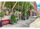 Charming storefront with lush greenery, decorative wreaths, plants, and brick building exterior at 5920 Bond St # B206, Cumming, GA 30040