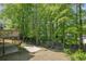View of backyard, including a deck, a patio, and a tree line at the back of the property at 701 Belgrave Ln, Tucker, GA 30084