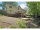 Exterior view of the home showcasing a spacious backyard with deck and patio at 701 Belgrave Ln, Tucker, GA 30084