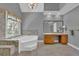 Bathroom with a large bathtub, walk-in shower, and vanity with sink at 701 Belgrave Ln, Tucker, GA 30084
