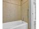Bathroom with tiled walls and shower, and a white bathtub at 701 Belgrave Ln, Tucker, GA 30084