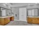 Bathroom featuring dual sinks, granite counters, and double door entry at 701 Belgrave Ln, Tucker, GA 30084