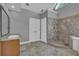 Bathroom featuring granite counters, dual sinks, walk-in shower, and tile flooring at 701 Belgrave Ln, Tucker, GA 30084