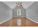 Bedroom with hardwood floors, vaulted ceiling, and a large arched window at 701 Belgrave Ln, Tucker, GA 30084