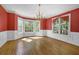 Bright dining room with hardwood floors, large windows, and wainscoting at 701 Belgrave Ln, Tucker, GA 30084
