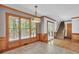 Sunny dining area with wood paneled walls, tile floors and large windows at 701 Belgrave Ln, Tucker, GA 30084