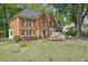 Charming brick home with a manicured lawn and blooming azaleas adding curb appeal at 701 Belgrave Ln, Tucker, GA 30084