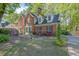 Charming brick home featuring mature landscaping, colorful azaleas, and a well-maintained front yard at 701 Belgrave Ln, Tucker, GA 30084
