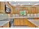 Close up of kitchen featuring wood cabinets, modern appliances and countertops at 701 Belgrave Ln, Tucker, GA 30084