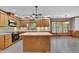 Large eat-in kitchen featuring wood cabinets, an island and modern lighting at 701 Belgrave Ln, Tucker, GA 30084