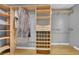 Custom walk-in closet with shelving and hanging rods at 701 Belgrave Ln, Tucker, GA 30084