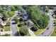 Gorgeous aerial view of this home's location surrounded by mature trees, sidewalks, and manicured lawns at 1806 Royal Troon Ct, Duluth, GA 30097