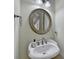 Charming powder room features a decorative mirror and pedestal sink at 1806 Royal Troon Ct, Duluth, GA 30097