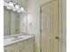 Well-lit bathroom featuring a vanity with a white marble countertop, a large mirror, and decorative lighting fixtures at 1806 Royal Troon Ct, Duluth, GA 30097