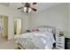 Comfortable bedroom with carpet flooring, a ceiling fan, and a connected bathroom at 1806 Royal Troon Ct, Duluth, GA 30097