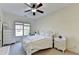 Cozy bedroom featuring natural lighting, carpeted floors, and a ceiling fan for comfortable climate control at 1806 Royal Troon Ct, Duluth, GA 30097