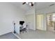 Bright bedroom featuring neutral colors, carpet flooring, a ceiling fan, and a dedicated desk space for work or study at 1806 Royal Troon Ct, Duluth, GA 30097