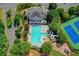 Overhead view of sparkling community pool with a slide, playground and tennis courts at 1806 Royal Troon Ct, Duluth, GA 30097