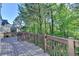 Wooden deck with railing overlooking green trees at 1806 Royal Troon Ct, Duluth, GA 30097