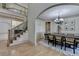 Bright dining room featuring hardwood floors, chandelier, and view of staircase at 1806 Royal Troon Ct, Duluth, GA 30097