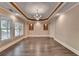 Spacious dining room with hardwood floors, recessed lighting, and elegant chandelier at 1806 Royal Troon Ct, Duluth, GA 30097